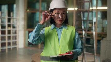 Asian woman building inspector Chinese Korean girl Japanese engineer architect look through magnifier vision factory builder looking magnifying glass big zoomed eye analyzing searching investigation video