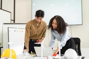 Collaboration in Renewable Solutions. A focused team working on innovative designs in a modern office setting. photo