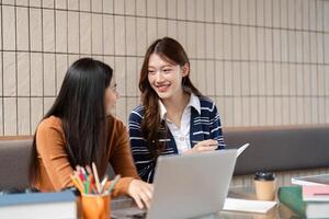Study Partnership and Connectedness. Friends working together, sharing knowledge and ideas at a study desk. photo