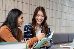 Learning and Engagement. Two students happily collaborating on a project, smiling and writing notes. photo