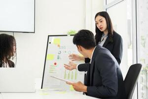 Data Analysis and Decision-Making in Sustainability. A team member elaborates on ESG metrics during a presentation. photo