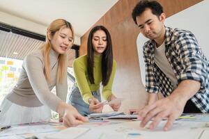 Diverse team discussing design ideas and collaborating at modern office table. photo