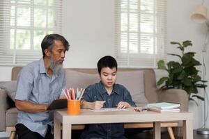 Guided Learning and Creativity. A grandfather overseeing a child during a drawing session. photo