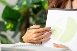 Data Presentation and Analysis. A professional woman discussing a pie chart during a virtual meeting. photo