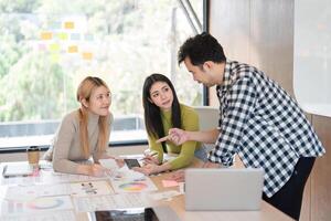 Diverse team discussing design concepts and collaborating in a modern office. photo