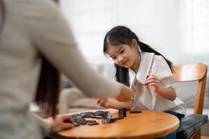 Joyful Connection Through Play. A delightful game between mother and daughter fostering a playful atmosphere. photo