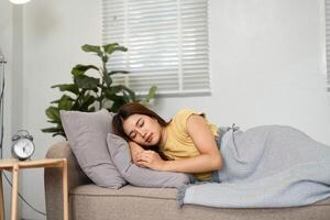 Morning Sleep and Relaxation. A young woman peacefully sleeping on a cozy couch, embracing the comfort of home in a serene setting. photo