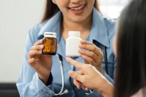 Medication Review and Patient Understanding. A healthcare professional is showing medication options to a patient during a health consultation. photo
