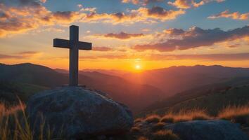 Cross on the mountain at sunset photo