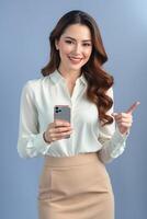 Portrait of asian woman holding smartphone and pointing finger photo