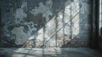 Aged Industrial Factory Wall with Peeling Grey Paint, Exposed Brick Texture, and Natural Light Shadows in an Abandoned Building Interior photo