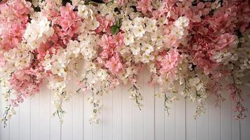Delicate Combination of White and Pink Flowers Suspended Gracefully with Green Foliage Accents on a Minimalist Backdrop photo