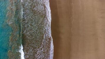 Aerial View of Waves Crashing on Sandy Beach, East Java, Lenggoksono Beach photo