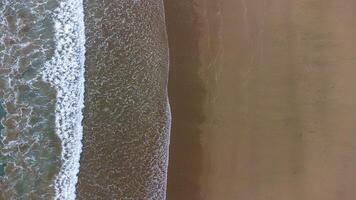 Aerial View of Waves Crashing on Sandy LenggoksonoBeach photo