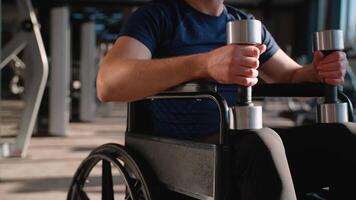 Close-up of wheelchair user holding dumbbells video
