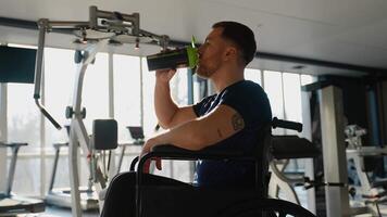 Wheelchair user athlete drinking protein shake after training video