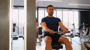Man doing seated cable row back exercise in gym video