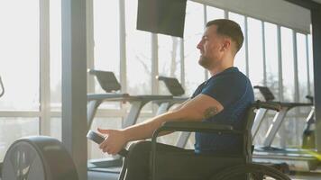 Man in wheelchair training at gym video