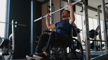 Man in wheelchair lifting barbell in gym video