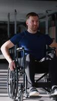 Confident man in a wheelchair moves independently through modern gym, representing mobility, strength, and an active adaptive lifestyle video