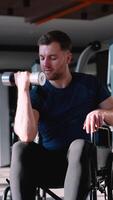 Man in wheelchair doing bicep curl exercise video