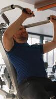 Man using lat pulldown machine at gym video