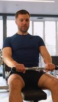 Man doing seated cable row back exercise in gym video