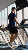 Man running on treadmill at modern gym video