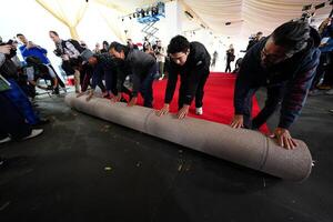 Workers during the ceremonial “red carpet rollout” event before the 94th annual Academy Awards at the Dolby Theatre on March 9, 2024. editorial_image