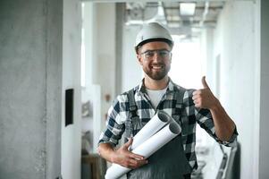Construction worker in uniform in empty, unfinished room photo