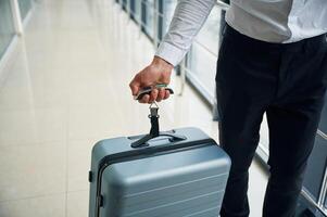 Weight ,of luggage bag. Close up view of man in formal clothes, conception of airport travel photo