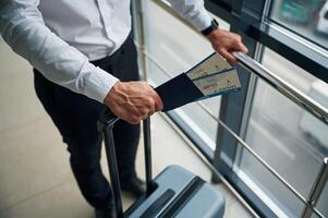 Close up,, view of man with luggage and in formal clothes, conception of airport travel photo