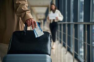 Man,, arrives from the flight in the airport entrance hall, woman is meeting him with name blank photo