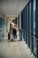 Embracing each other. Couple, are, in, the airport hall together photo