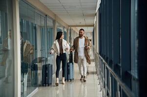 Front ,view, walking... Couple are in the airport hall together photo