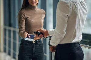 Woman, is with airport worker,, with tickets photo