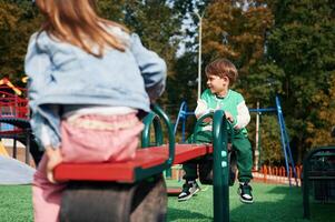 Beautiful ,sunlight. Kids ,are having fun on the playground photo