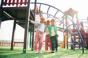 Front ,view. Kids are having fun on the playground photo