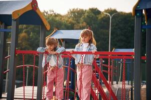 In casual clothes. Kids are having fun, on ,the playground photo