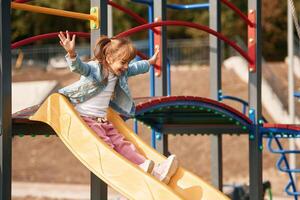 Little ,girl is having fun on the playground photo