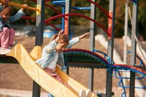 Little, girl is, having fun on the playground photo