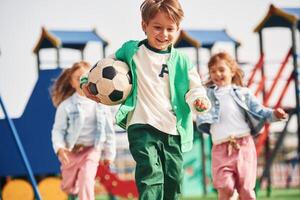 Cheerful, kids, are having fun on the playground photo