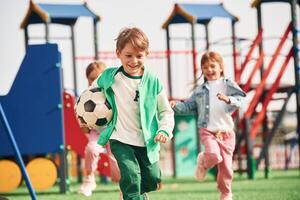 Cheerful, kids are having fun on the playground photo