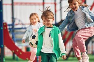 On ,the playground. Kids are having fun together photo