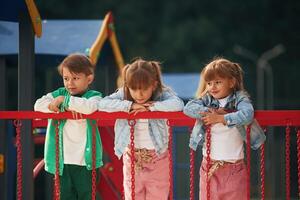 Children,, are active, smiling. Kids are having fun on the playground photo