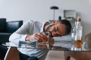 Life ,crisis. With whiskey. Upset young man drinker alcoholic is indoors photo