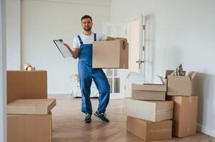 Room, full of boxes. Moving service employee photo