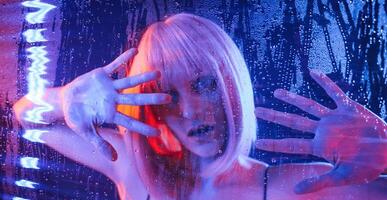 Trapped, inside,, with hands on surface. Stylish woman with white hair is behind wet transparent plastic sheet photo