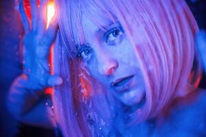 Blue, color in the front and red is behind. Stylish woman with white hair is behind wet transparent plastic sheet photo