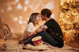 Conception,, of, love. Beautiful young couple indoors, celebrating new year against projector photo